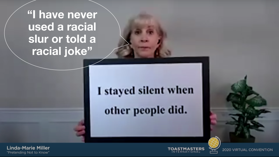 Video still of Toastmaster Linda-Marie Miller with a speech bubble saying, “I have never used a racial slur or told a racial joke,” while holding up a sign that says, "I stayed silent while other people did."